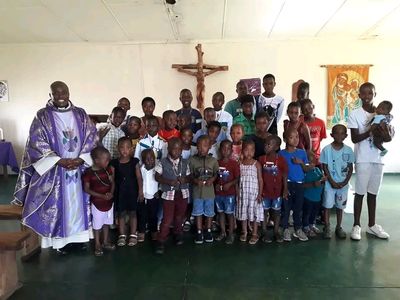 Emmanuel with children in the community